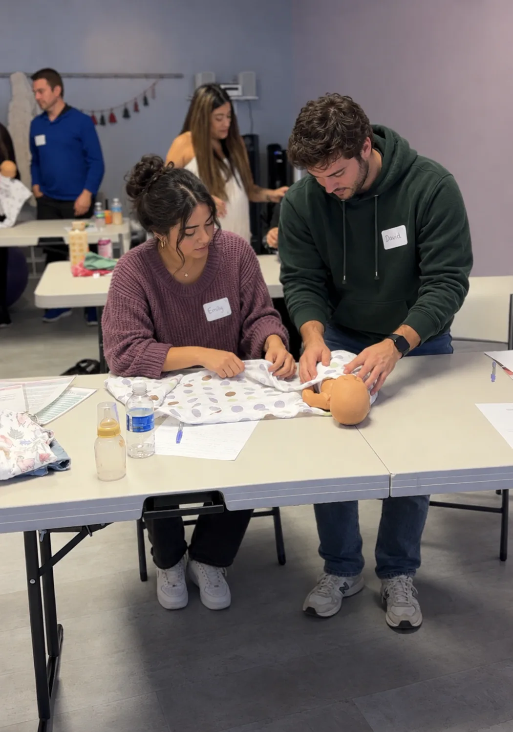 Newborn Care Class couple swaddling baby
