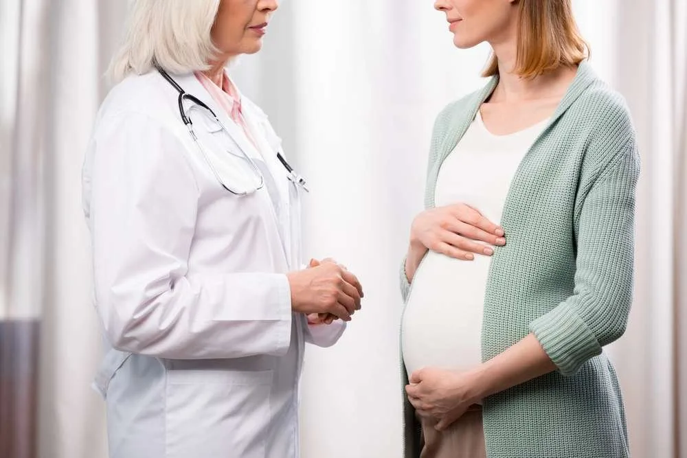 Pregnant mom consulting with doctor