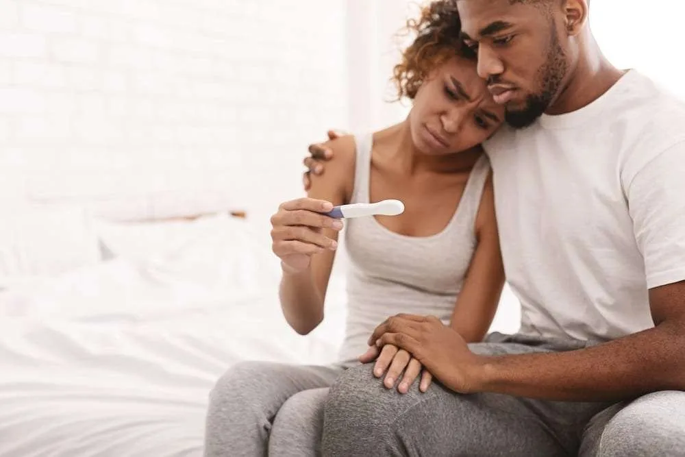 Black couple with a negative pregnancy test result
