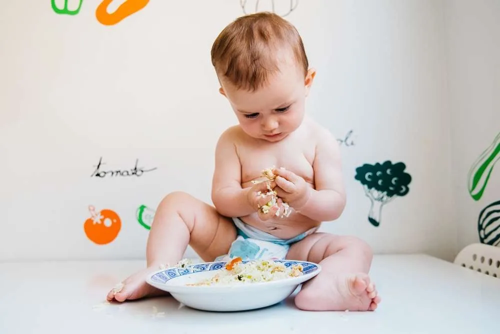 Baby trying foods with baby-led weaning