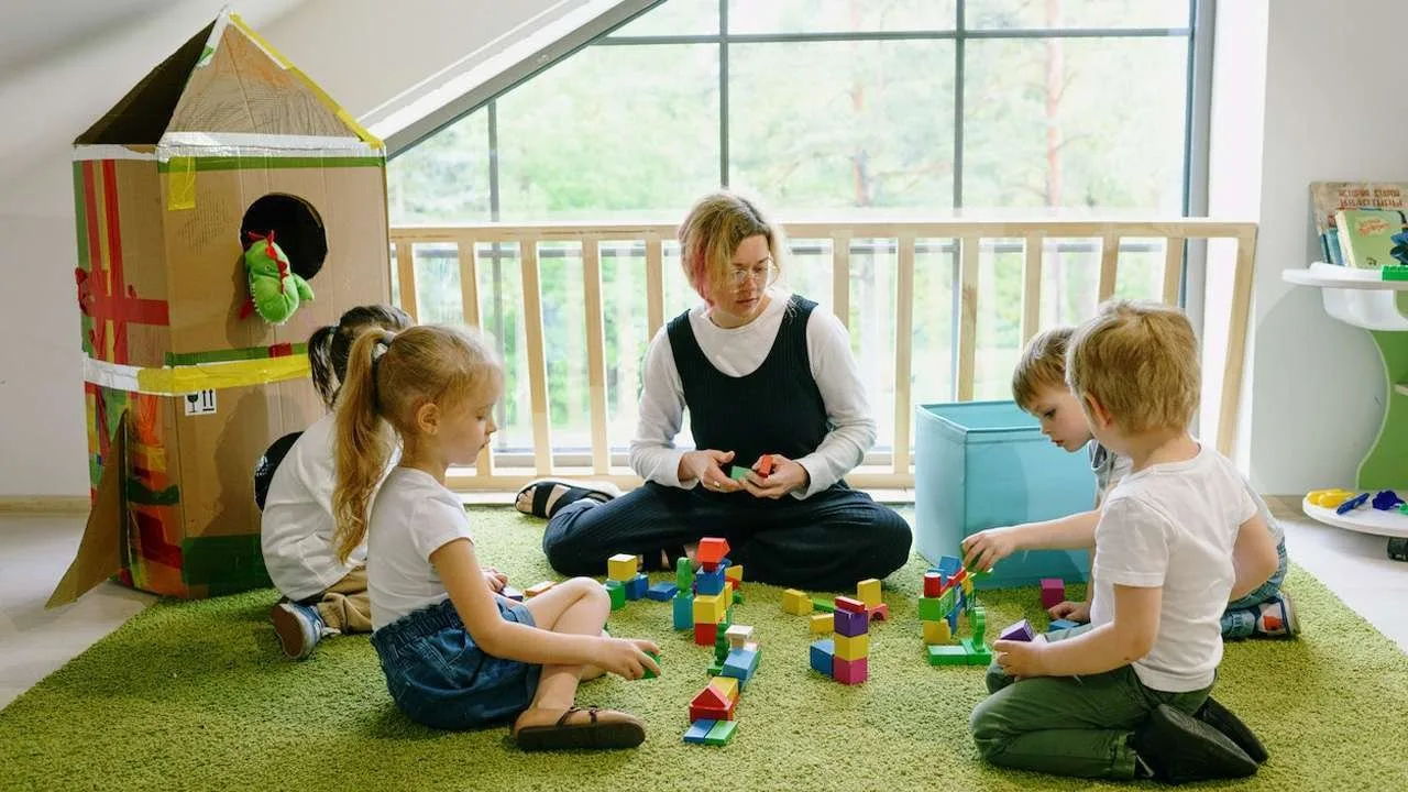 Nanny playing blocks with kids