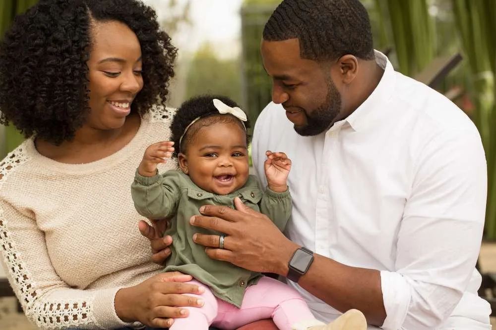 Happy African American family with their baby.