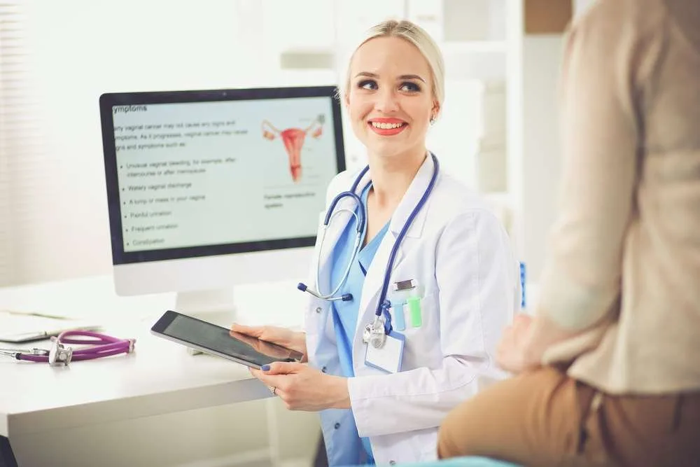 Doctor and patient discussing something while sitting at the table . Medicine and health care concept. Doctor and patient