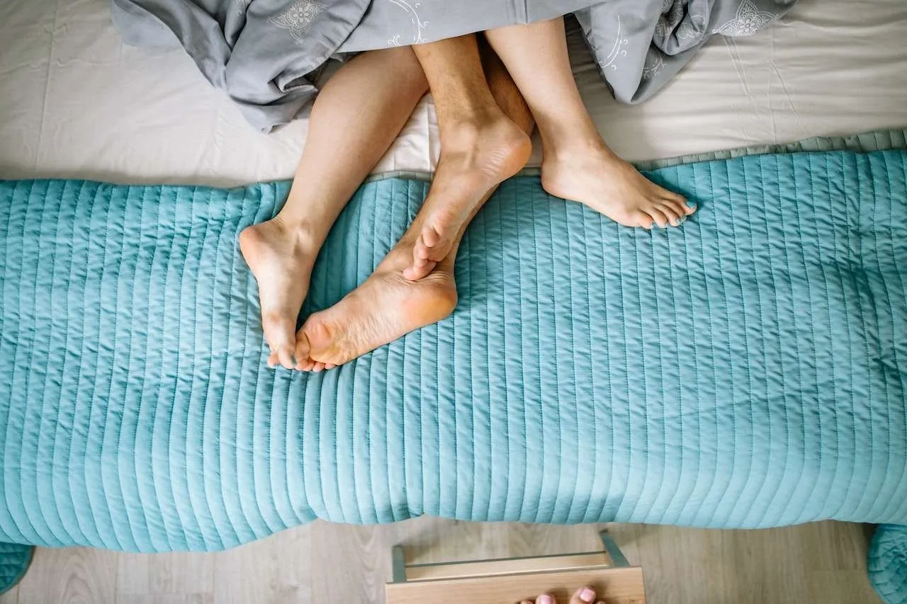 man and woman in bed
