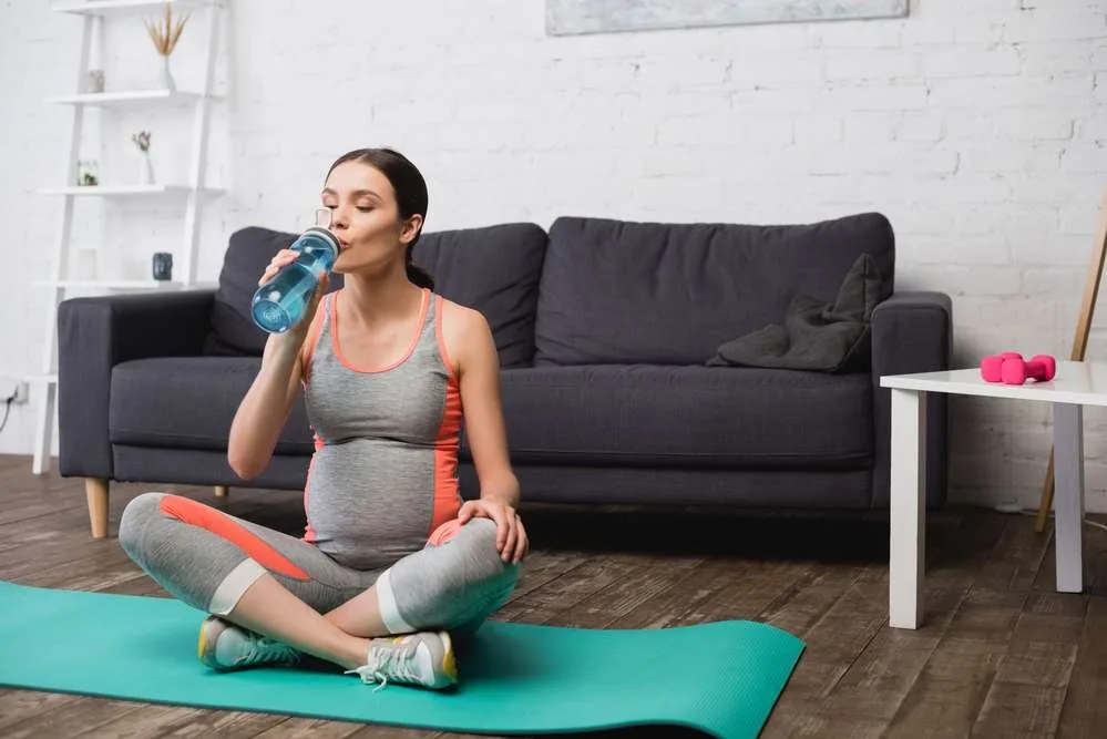 pregnant woman drinking water