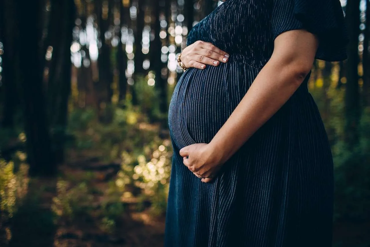 Pregnant woman holding stomach
